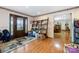 Warm entryway featuring hardwood floors, decorative shelving, and a welcoming doorway to the dining room at 907 Sikes Mill Rd, Monroe, NC 28110