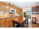 Open kitchen with wood cabinets, granite counters, and stainless steel appliances at 907 Sikes Mill Rd, Monroe, NC 28110