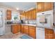 Functional kitchen with oak cabinets, granite countertops and natural light at 907 Sikes Mill Rd, Monroe, NC 28110