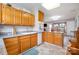 Functional kitchen with wood cabinets, granite countertops, and tile floors at 907 Sikes Mill Rd, Monroe, NC 28110