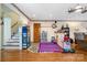 Multipurpose living space with hardwood floors, neutral walls, and access to a staircase at 907 Sikes Mill Rd, Monroe, NC 28110