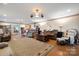 Spacious living room with hardwood floors, comfortable seating, and a large area rug at 907 Sikes Mill Rd, Monroe, NC 28110