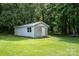 View of shed on property with vinyl siding, small window, and door at 907 Sikes Mill Rd, Monroe, NC 28110