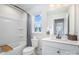 Bathroom showcasing tub and shower, a window, and a white vanity and sink at 980 Prince Garrett Way, Denver, NC 28037