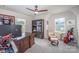 Bright room with two windows, a ceiling fan, carpet, and a display cabinet at 980 Prince Garrett Way, Denver, NC 28037