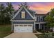 Charming two-story home with a two car garage, stone accents, and neatly manicured landscaping at 980 Prince Garrett Way, Denver, NC 28037