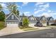 A row of charming two-story homes featuring garages, stone accents, and well-maintained lawns at 980 Prince Garrett Way, Denver, NC 28037