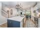 Spacious kitchen with a large island, modern lighting, and stainless appliances, seamlessly connects to living room at 980 Prince Garrett Way, Denver, NC 28037