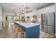 Contemporary kitchen with a large island, barstool seating, stainless appliances, and seamlessly connects to the living room at 980 Prince Garrett Way, Denver, NC 28037