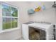 Bright laundry room with modern washer and dryer and a large window providing natural light at 980 Prince Garrett Way, Denver, NC 28037