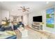 Spacious living room featuring modern ceiling fan, luxury vinyl flooring, and a cozy fireplace at 980 Prince Garrett Way, Denver, NC 28037