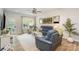 Bright living room with stylish furniture, hardwood floors, and a large window overlooking the backyard at 980 Prince Garrett Way, Denver, NC 28037
