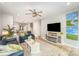 Spacious living room featuring modern ceiling fan, luxury vinyl flooring, and a cozy fireplace at 980 Prince Garrett Way, Denver, NC 28037