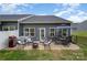 Outdoor patio with dining table, seating, an umbrella, grill and a view of the backyard at 980 Prince Garrett Way, Denver, NC 28037