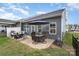 Outdoor patio with dining table, seating, an umbrella, and a view of the backyard at 980 Prince Garrett Way, Denver, NC 28037