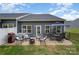 Outdoor patio with dining table, seating, an umbrella, grill and a view of the backyard at 980 Prince Garrett Way, Denver, NC 28037