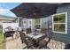 Spacious brick patio with outdoor dining set, umbrella and additional patio seating at 980 Prince Garrett Way, Denver, NC 28037