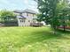Expansive backyard with mature trees and a wooden deck at 10008 King George Ln, Waxhaw, NC 28173