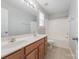 Bathroom featuring double sinks, wood cabinets, and shower-tub combo at 10008 King George Ln, Waxhaw, NC 28173