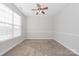 Bedroom featuring neutral walls, one window, carpet flooring, and a ceiling fan at 10008 King George Ln, Waxhaw, NC 28173