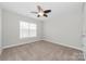 Neutral bedroom features a ceiling fan and bright window at 10008 King George Ln, Waxhaw, NC 28173