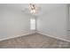 Neutral bedroom features a ceiling fan and bright window at 10008 King George Ln, Waxhaw, NC 28173