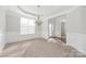 Bright dining room featuring classic wainscoting, a chandelier, and large windows at 10008 King George Ln, Waxhaw, NC 28173