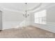 Spacious dining room with a chandelier, wainscoting, and natural light at 10008 King George Ln, Waxhaw, NC 28173