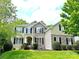 Charming two-story home featuring stone accents, black shutters, and lush landscaping for great curb appeal at 10008 King George Ln, Waxhaw, NC 28173