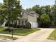 Two-story home with a stone accent, two-car garage, and well-maintained landscaping at 10008 King George Ln, Waxhaw, NC 28173