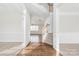 Bright foyer showcasing hardwood floors, staircase with decorative balusters, and adjacent rooms at 10008 King George Ln, Waxhaw, NC 28173