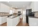 Bright eat-in kitchen featuring white cabinets, a center island, and stainless steel appliances at 10008 King George Ln, Waxhaw, NC 28173