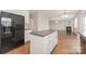 Open concept kitchen showcasing an island, hardwood floors, and modern appliances at 10008 King George Ln, Waxhaw, NC 28173