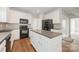 Well-equipped kitchen featuring an island, stainless steel appliances, and white cabinetry at 10008 King George Ln, Waxhaw, NC 28173