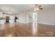 Spacious living room with hardwood floors offers a seamless flow to the staircase, kitchen, and foyer at 10008 King George Ln, Waxhaw, NC 28173