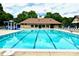 A large outdoor community pool with ample seating and a splash pad at 10008 King George Ln, Waxhaw, NC 28173