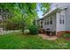 Backyard featuring an outdoor grill, a screened-in porch, a white picket fence and plenty of green space at 10434 Blackstock Rd, Huntersville, NC 28078