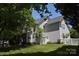 Backyard features a large lawn, white picket fence, screened-in porch, and mature trees at 10434 Blackstock Rd, Huntersville, NC 28078