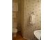 Small bathroom with cream wallpaper, white towels, and a clean white toilet at 10434 Blackstock Rd, Huntersville, NC 28078