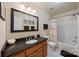 Well-lit bathroom featuring modern vanity, large mirror, and a shower-tub combination at 10434 Blackstock Rd, Huntersville, NC 28078