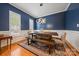Elegant dining room with modern lighting, dark blue walls, and seating for six at 10434 Blackstock Rd, Huntersville, NC 28078