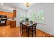 Charming dining room featuring hardwood floors, bright windows, and a view of the backyard at 10434 Blackstock Rd, Huntersville, NC 28078