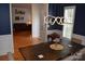 Dining room features dark wood table, elegant lighting, navy walls with white trim, and hardwood floors at 10434 Blackstock Rd, Huntersville, NC 28078