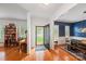 Bright entryway features hardwood floors, an open doorway and adjacent dining and living spaces at 10434 Blackstock Rd, Huntersville, NC 28078