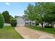 Well-maintained two-story home with attached garage, lush lawn, and mature trees in a pleasant neighborhood at 10434 Blackstock Rd, Huntersville, NC 28078