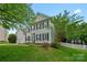Charming two-story home featuring manicured landscaping, black shuttered windows, and attached garage at 10434 Blackstock Rd, Huntersville, NC 28078