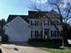 Beautiful two-story house with a well-manicured front lawn, attached garage, and classic black shutters at 10434 Blackstock Rd, Huntersville, NC 28078