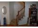 Foyer features hardwood floors, staircase with wood railing, and decorative shelving at 10434 Blackstock Rd, Huntersville, NC 28078