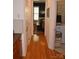 Hallway with hardwood floors and views of the dining room and laundry area at 10434 Blackstock Rd, Huntersville, NC 28078