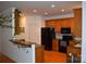 Well-lit kitchen boasts wooden cabinetry, black appliances, and an open layout, perfect for modern living at 10434 Blackstock Rd, Huntersville, NC 28078